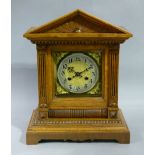 A Victorian oak cased mantel clock with architectural pediment, above a reel moulded frieze, the