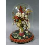 A Victorian ornament worked in coloured walls with flowers in a hand 'vase' the base plush velvet