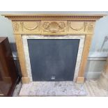 A reproduction pine fire place in George III style the moulded shelf above a dentil cornice the