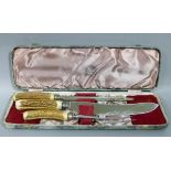 A set of three carving knives with antler handles comprising, steel, knife and fork, cased