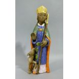 Francoys - a pottery figure of a bishop with lamb at his feet, he holds a staff with yellow glazed