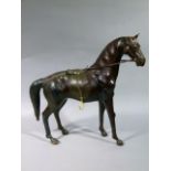 A reproduction leather cased horse, 48cm high