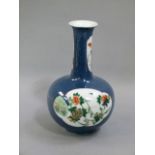 A Chinese powder blue bottle vase decorated to the body with a pair of shaped oval panels painted