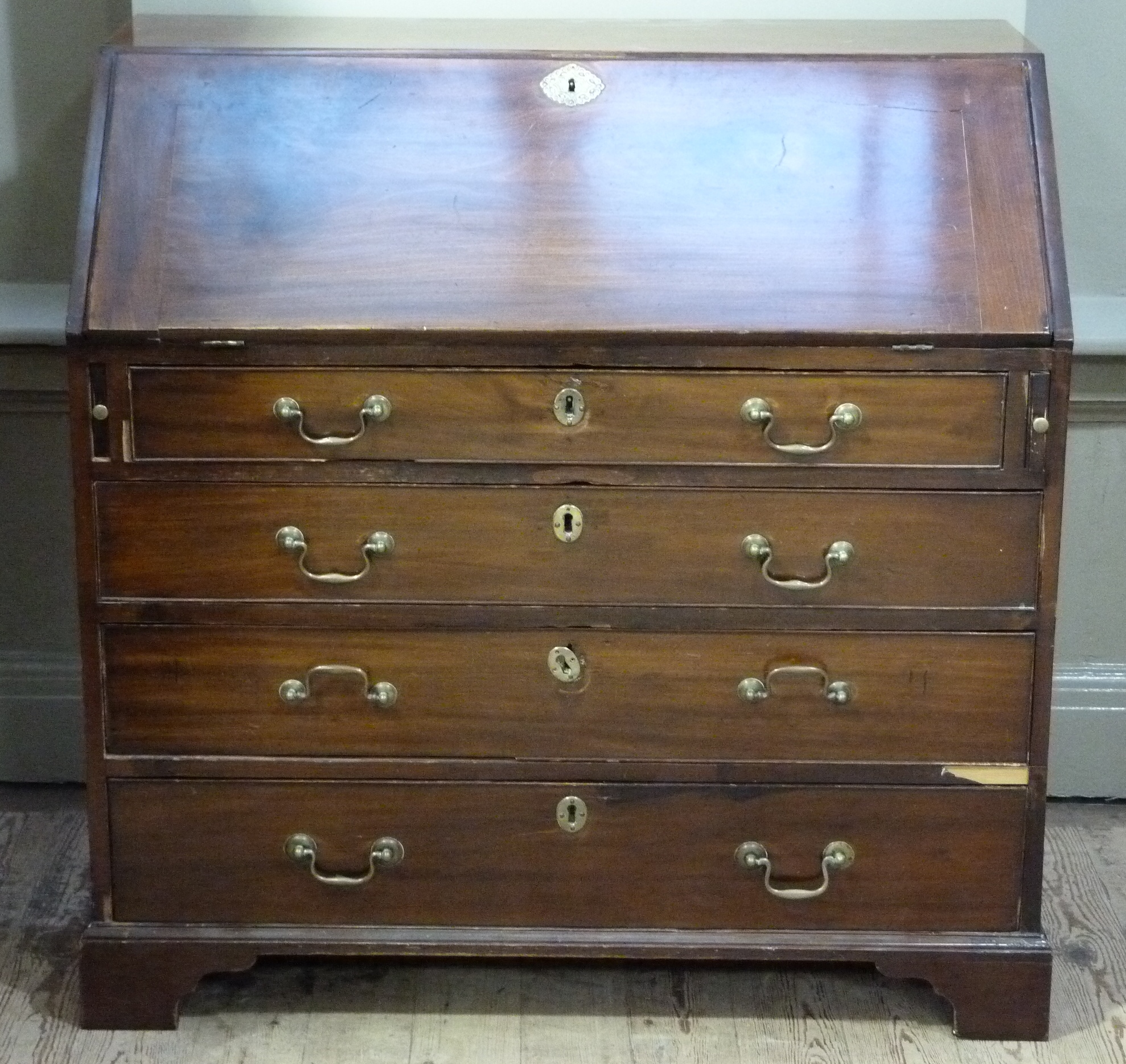 A George III mahogany bureau, the fall flap revealing conventionally fitted interior above pair of