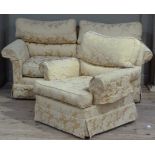 A two piece lounge suite upholstered in yellow cotton damask