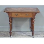 A Victorian pitch pine single drawer writing table the oversailing top above single drawer, turned