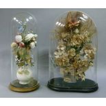 A Victorian floral ornament of dried and fabric flowers and grasses contained in a white porcelain