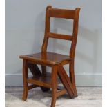 A reproduction mahogany metamorphic library chair with concave horizontal rails, border seat and