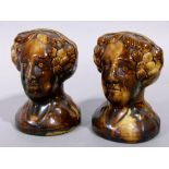 A pair of Victorian Staffordshire pottery treacle glazed furniture rests, modelled as female