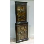 An Edwardian mahogany stained stand and corner cabinet with bevelled glazed upper and lower doors