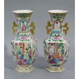 A pair of Chinese famille rose two handled hexagonal vases, the waisted necks with pierced