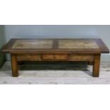 A reproduction oak and fruitwood coffee table the rectangular top with broad frame and inset panel