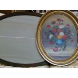 An oak framed, bevelled edged oval wall mirror, together with a still life oil painting by R Cook,