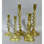 A pair of open barley twist brass table candle sticks, 30cm high; another smaller pair and a