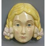 A Beswick ware pottery wall mask number 393, modelled as a young woman with blonde pigtails, 21cm