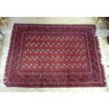 A modern red, black and white ground Bokhara carpet, the central field worked with five rows of
