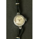 A LADY'S DIAMOND SET WRISTWATCH IN 18CT WHITE GOLD, c.1958 , Swiss jewelled lever movement by Felsa,