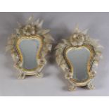A PAIR OF VENETIAN GLASS STRUT-BACKED SMALL MIRRORS, wheel engraved plates, each of waisted oval