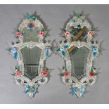 A PAIR OF VENETIAN WALL MIRRORS of arched and waisted outline, the top plate etched with leaf