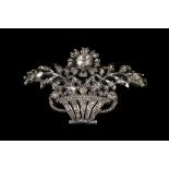 A MID 20TH CENTURY DIAMOND SET BROOCH in silver the pierced floral display basket set with rose