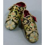 A PAIR OF 17TH CENTURY CHILD'S SHOES embroidered in coloured silks and gilt metal thread with