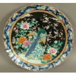 A 19TH CENTURY CHINESE FAMILLE NOIR SHAPED CIRCULAR CHARGER, decorated in polychrome enamels with