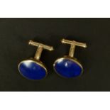 A PAIR OF LAPIS LAZULI CUFFLINKS in 9ct gold each collet set with an oval cabochon stone with