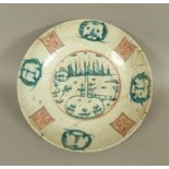 A CHINESE PORCELAIN CIRCULAR CHARGER decorated to the centre in green and black with stylised