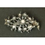 A DIAMOND SPRAY BROOCH in silver, the rose cut stones in cut down setting within the pierced foliate