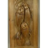 AN ARTS AND CRAFTS PANEL FINELY CARVED WITH THREE HUNG FISH, realistically detailed with textured