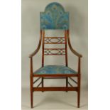 A SCOTTISH ARTS AND CRAFTS MOVEMENT INLAID AND GRAINED MAHOGANY ELBOW CHAIR, the arched padded