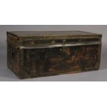 A 19TH CENTURY LEATHER CLOSE NAILED AND BRASS BOUND TRUNK with side carrying handles, 93cm wide x