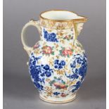 A WORCESTER CABBAGE LEAF MOULDED MASK JUG decorated in underglaze blue with three floral sprays