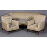 HOWARD & SONS, BERNERS ST, LONDON - a three seater sofa and pair of armchairs, all on mahogany