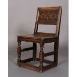 AN 18TH CENTURY OAK SINGLE CHAIR , the panelled back carved with roundels and leafage, boarded seat,