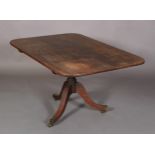 A REGENCY MAHOGANY TILT TOP BREAKFAST TABLE of rounded rectangular form, turned baluster column on