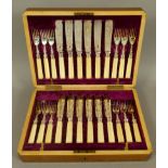 A LATE VICTORIAN MAHOGANY CANTEEN of twelve silver plated and ivory handled fish knives and forks by