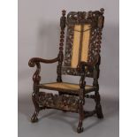 A FLEMISH WALNUT ARMCHAIR 17TH CENTURY AND LATER, having a pierced cresting carved with foliate