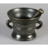 A 17TH CENTURY DUTCH BRONZE PESTLE AND MORTAR of flared cylindrical form, the upper rim inscribed:
