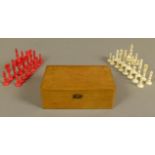 A BONE AND RED STAINED BONE CHESS SET, king 9cm high, boxed