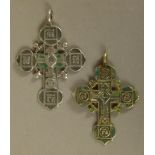 AN ENGRAVED SILVER COLOURED METAL RUSSIAN CRUCIFIX, the front cast and with remnants of green enamel