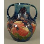 A WALTER MOORCROFT FINCHES AND BERRIES DESIGN TWO HANDLED VASE c.1988 tubelined and glazed in pink