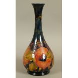 A WILLIAM MOORCROFT POMEGRANATE VASE c.1916, the bottle shape with flared rim and on foot rim,