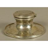 A GEORGE V SILVER CAPSTAN INKWELL of conventional form, the hinged lid engraved with SS emblem