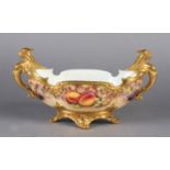 A ROYAL WORCESTER STILL LIFE PAINTED TWO HANDLED PORCELAIN BOWL of oval form with gilt sphinx type