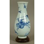A CHINESE BLUE AND WHITE BALUSTER VASE painted in underglaze blue with hunters on horseback with dog