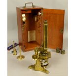 A 19TH CENTURY BRASS MICROSCOPE BY C. BAKER OF LONDON, complete with lenses, magnifier and drawer of