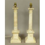 A PAIR OF ALABASTER COLUMN TABLE LAMPS with lobed and palmette carved capitals and conforming bases,