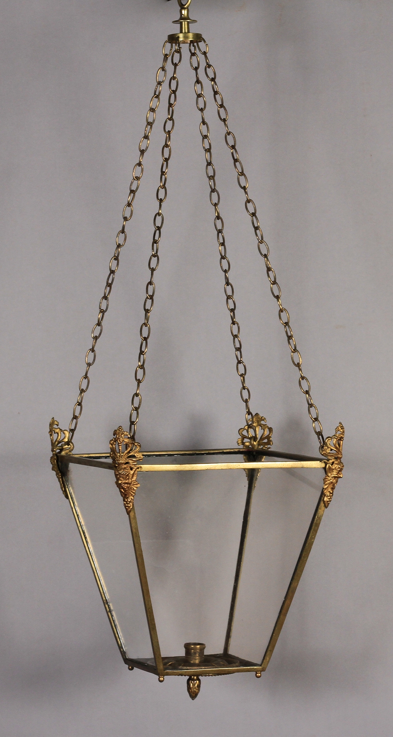 A 19TH CENTURY BRASS FRAMED HALL LANTERN of tapered square form, each corner clasped with a