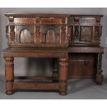 AN OAK SERVING TABLE in 17th century style, the projecting canopy above a deep frieze with applied